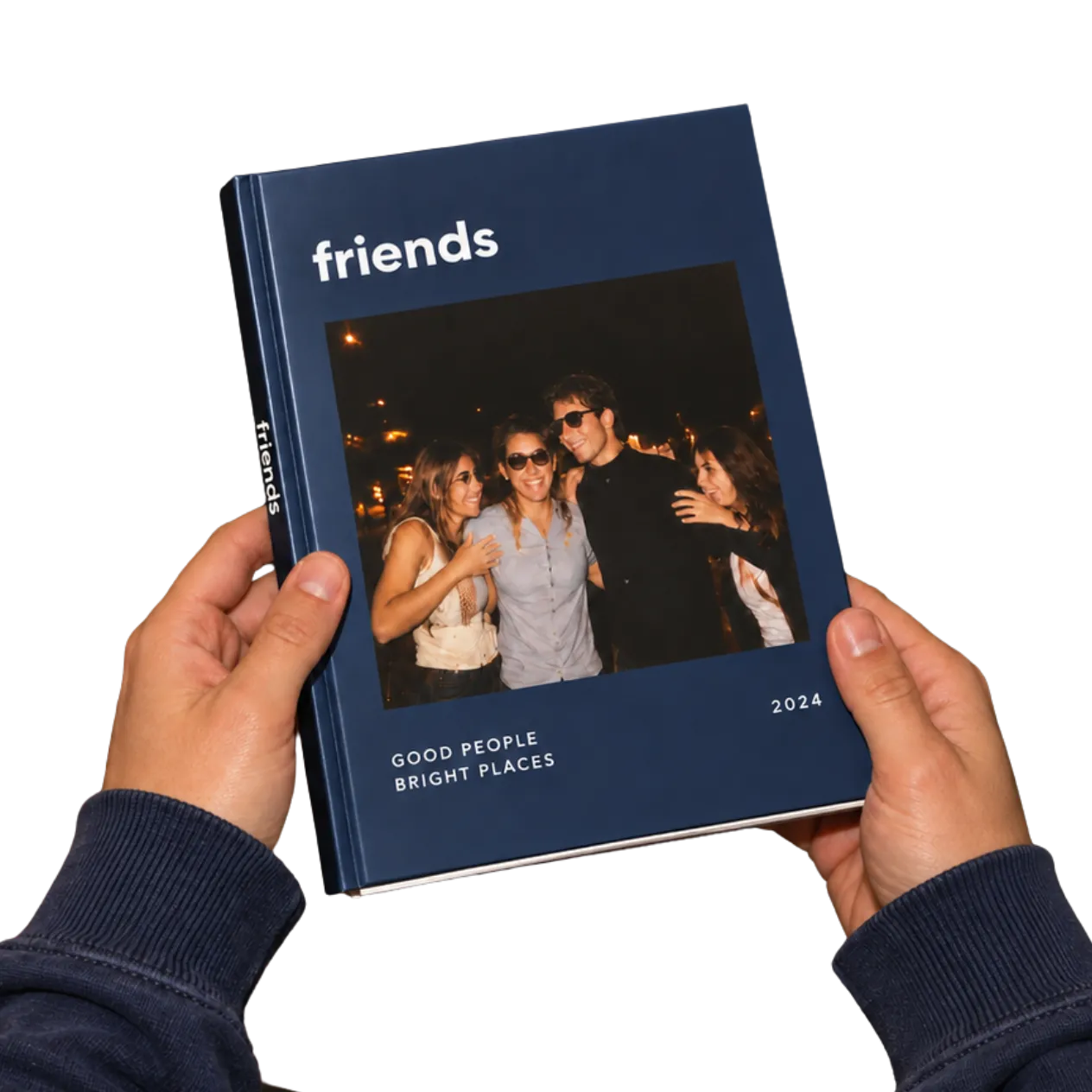 A Dailies hardcover photo book held in two hands